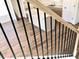 Staircase with wood and metal railing with view of the kitchen island at 195 Ridgecrest Way, Stockbridge, GA 30281