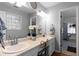 Bathroom with a double vanity sink, large mirror, and a window for natural light at 1878 Hamby Place Nw Dr, Acworth, GA 30102