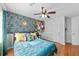 Bedroom with hardwood floors, colorful wall decor, and a ceiling fan at 1878 Hamby Place Nw Dr, Acworth, GA 30102
