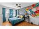 Bedroom with hardwood floors, colorful wall decor, and a ceiling fan at 1878 Hamby Place Nw Dr, Acworth, GA 30102
