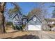 Charming two-story home featuring a blue exterior, attached garage, and a welcoming yellow front door at 1878 Hamby Place Nw Dr, Acworth, GA 30102
