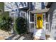 Charming front porch with yellow door and tasteful decor, creating a welcoming entrance at 1878 Hamby Place Nw Dr, Acworth, GA 30102