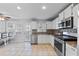 Kitchen with stainless steel appliances, white cabinets, tile backsplash, breakfast bar, and exterior access at 1878 Hamby Place Nw Dr, Acworth, GA 30102