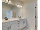 Double vanity bathroom with white cabinets and black hardware at 214 Depot Landing Rd # 62, Auburn, GA 30011