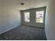 Bright bedroom with gray carpet, neutral walls, and two windows offering ample natural light at 214 Depot Landing Rd # 62, Auburn, GA 30011