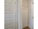 Bright white coat closet with hooks and wood flooring at 214 Depot Landing Rd # 62, Auburn, GA 30011