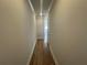 Hallway featuring wood-look flooring leading to an open, bright living space at 214 Depot Landing Rd # 62, Auburn, GA 30011