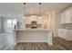 Modern kitchen with white cabinets, granite counters, and island at 214 Depot Landing Rd # 62, Auburn, GA 30011