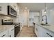 Modern kitchen with white cabinets, granite counters and stainless steel appliances at 214 Depot Landing Rd # 62, Auburn, GA 30011