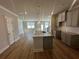 Modern kitchen with a granite island, gray cabinetry, and stainless steel appliances at 214 Depot Landing Rd # 62, Auburn, GA 30011