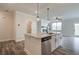 Modern kitchen with island, white cabinets, and granite countertops at 214 Depot Landing Rd # 62, Auburn, GA 30011