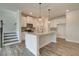 Modern kitchen with white cabinets, granite counters, and island at 214 Depot Landing Rd # 62, Auburn, GA 30011