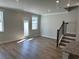 Bright living room featuring a door to the outside and a staircase at 214 Depot Landing Rd # 62, Auburn, GA 30011