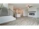 Open living room showcasing a fireplace, hardwood floors, and a kitchen at 214 Depot Landing Rd # 62, Auburn, GA 30011