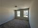 Comfortable bedroom with carpeted floors and bright windows offering neighborhood views at 216 Depot Landing Rd # 61, Auburn, GA 30011