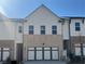 Charming townhome featuring a brick and siding facade, complemented by a convenient two-car garage at 216 Depot Landing Rd # 61, Auburn, GA 30011