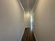 A long hallway leading into the home featuring hardwood floors and neutral paint at 216 Depot Landing Rd # 61, Auburn, GA 30011