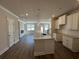Open-concept kitchen featuring a granite island, stainless fixtures, white cabinets, and hardwood floors at 216 Depot Landing Rd # 61, Auburn, GA 30011