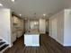 Open-concept kitchen featuring a granite island, stainless fixtures, white cabinets, and hardwood floors at 216 Depot Landing Rd # 61, Auburn, GA 30011