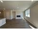 Bright, open-concept living room with luxury vinyl plank flooring and a modern fireplace at 216 Depot Landing Rd # 61, Auburn, GA 30011