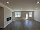 Living room featuring hardwood floors, modern fireplace, neutral paint, and access to the backyard at 216 Depot Landing Rd # 61, Auburn, GA 30011