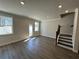 Spacious living room featuring hardwood floors, neutral paint, staircase, and access to the backyard at 216 Depot Landing Rd # 61, Auburn, GA 30011