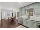 Eat-in kitchen with light green cabinets, stainless steel appliances, and a charming dining area at 425 Shepard Sw Dr, Marietta, GA 30064