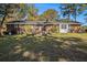 Backyard with a brick home, green grass, and a small deck for outdoor enjoyment at 2540 Thornton Dr, Atlanta, GA 30349