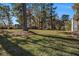 Sprawling backyard featuring lush green grass and mature trees, offering a serene outdoor space at 2540 Thornton Dr, Atlanta, GA 30349