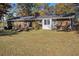 View of a brick home's backyard showcasing the lawn, exterior features, and landscaping at 2540 Thornton Dr, Atlanta, GA 30349