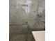 Modern bathroom features marble-look tile and convenient grab bars at 2540 Thornton Dr, Atlanta, GA 30349
