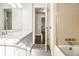 Bathroom featuring neutral tile, large mirror, vanity with marble countertop and a shower-tub combo at 2540 Thornton Dr, Atlanta, GA 30349