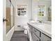 Well-lit bathroom with a marble countertop, sleek gray cabinetry, and a shower-tub combo at 2540 Thornton Dr, Atlanta, GA 30349