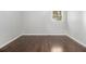 Well-lit empty bedroom with beautiful hardwood flooring and a window providing natural light at 2540 Thornton Dr, Atlanta, GA 30349