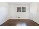 Well-lit bedroom with hardwood floors, closet, and a window bringing in natural light at 2540 Thornton Dr, Atlanta, GA 30349