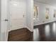 Bright entryway features beautiful dark wood floors and a white front door at 2540 Thornton Dr, Atlanta, GA 30349