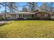 Charming brick ranch home with a manicured lawn and mature trees at 2540 Thornton Dr, Atlanta, GA 30349