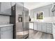 Well-equipped kitchen featuring stainless steel refrigerator and bright, light gray cabinets at 2540 Thornton Dr, Atlanta, GA 30349