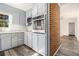 Modern kitchen with stainless steel microwave, oven, and light gray cabinets at 2540 Thornton Dr, Atlanta, GA 30349