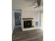 Inviting living room featuring a painted brick fireplace and ceiling fan at 2540 Thornton Dr, Atlanta, GA 30349
