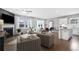 Open concept kitchen and living area with island and hardwood floors at 630 Pineberry Ct, Grayson, GA 30017