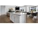 Large kitchen island with white cabinets and quartz countertop, perfect for casual dining at 630 Pineberry Ct, Grayson, GA 30017