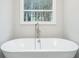 Elegant freestanding bathtub with a modern faucet at 3779 Churchill Sw Dr, Marietta, GA 30064