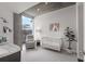 Bedroom with crib, armchair, and city view at 860 Peachtree Ne St # 2605, Atlanta, GA 30308