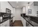 Modern galley kitchen with stainless steel appliances and dark countertops at 860 Peachtree Ne St # 2605, Atlanta, GA 30308