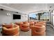 Community theater room with orange chairs and a large TV at 860 Peachtree Ne St # 2605, Atlanta, GA 30308