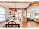 Dining area with hardwood floors and a red pendant light fixture at 1576 Temple Ave, Atlanta, GA 30337