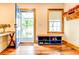 Inviting entryway with hardwood floors, built-in bench, and blue door at 1576 Temple Ave, Atlanta, GA 30337
