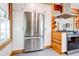 Stainless steel refrigerator in a kitchen with white cabinets and wood accents at 1576 Temple Ave, Atlanta, GA 30337