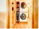Stackable washer and dryer in a well-organized laundry room with wood flooring at 1576 Temple Ave, Atlanta, GA 30337